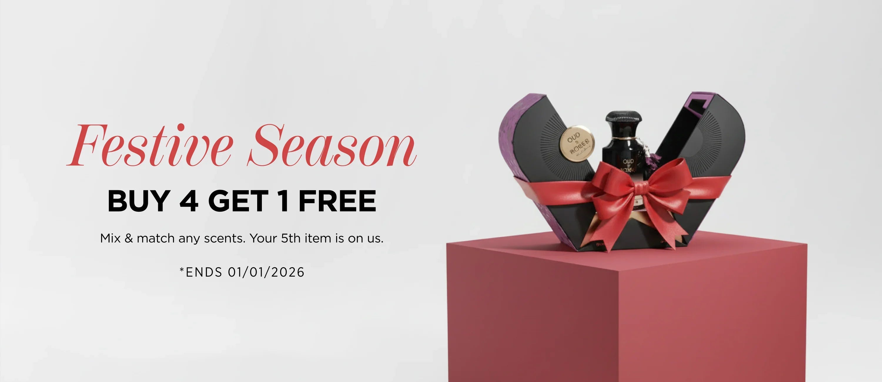 Luxury Oud Roses perfume in festive gift box with red bow, perfect for holiday gifting